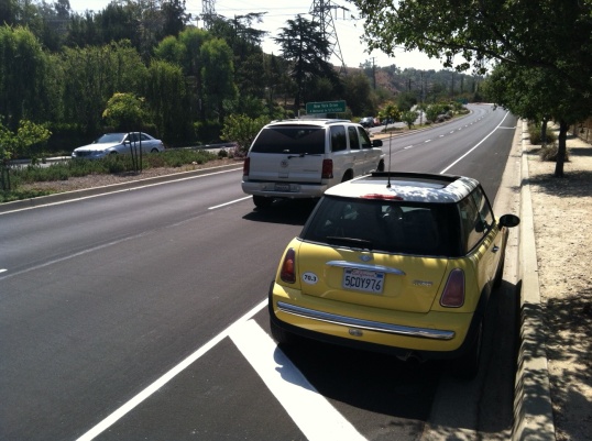 The weak link: cars parked on the shoulder require bikes to enter travel lane where cars approach 50 mph.