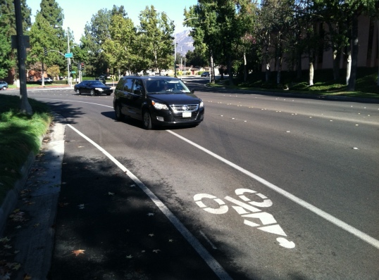 Drivers encroach on the bike lane on Rosemead Blvd at 40 mph. At least half of the cars in the right lane crossed into the bike lane on the morning I took this picture. A buffer and green paint in the lane would increase safety, as would a reduction in the 40 mph posted speed limit.  